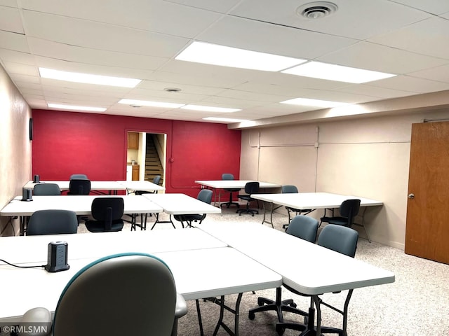 office space with a paneled ceiling