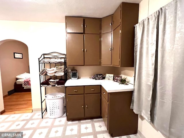 kitchen with a textured ceiling and light hardwood / wood-style flooring