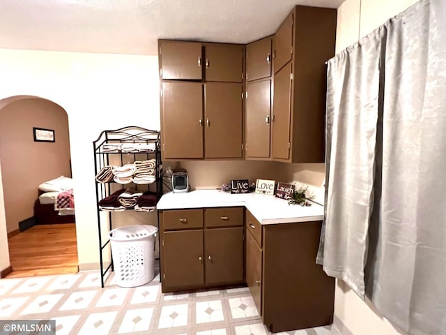 103 Pearl St, Adrian, MN 56110 - kitchen with light floors, gray cabinetry, light countertops, and arched walkways