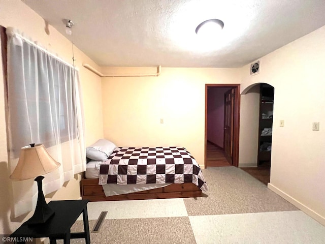 carpeted bedroom featuring a textured ceiling