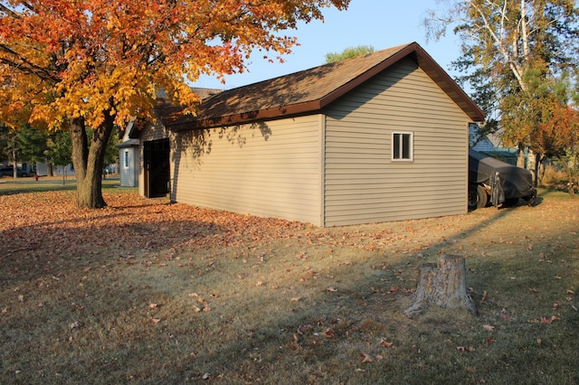 view of side of home with a lawn