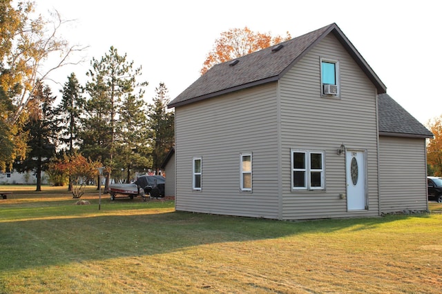 view of side of home with a lawn