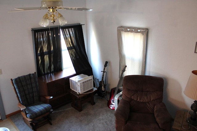 sitting room with ceiling fan, carpet, and a wall unit AC