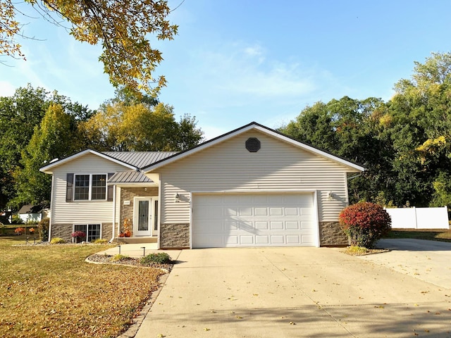 view of front of home featuring a garage and a front yard