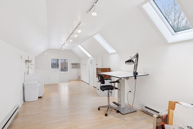 office space with an AC wall unit, a baseboard heating unit, vaulted ceiling with skylight, and light hardwood / wood-style flooring