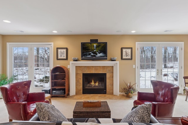 carpeted living room with a fireplace and french doors