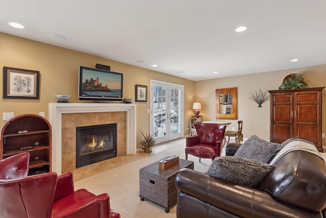 living room featuring light colored carpet and a tile fireplace