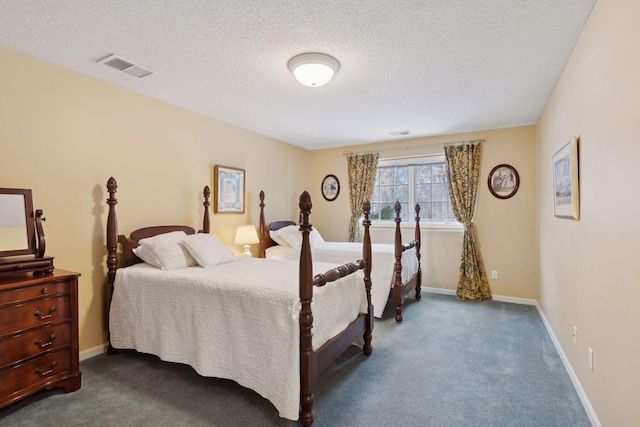 bedroom featuring a textured ceiling and carpet flooring