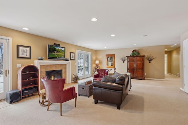 living room with light colored carpet and a fireplace