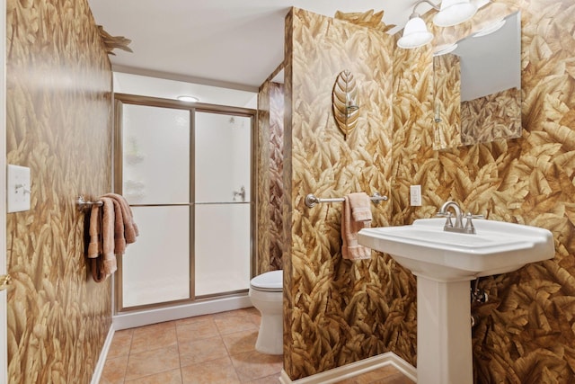 bathroom featuring an enclosed shower, tile patterned floors, and toilet