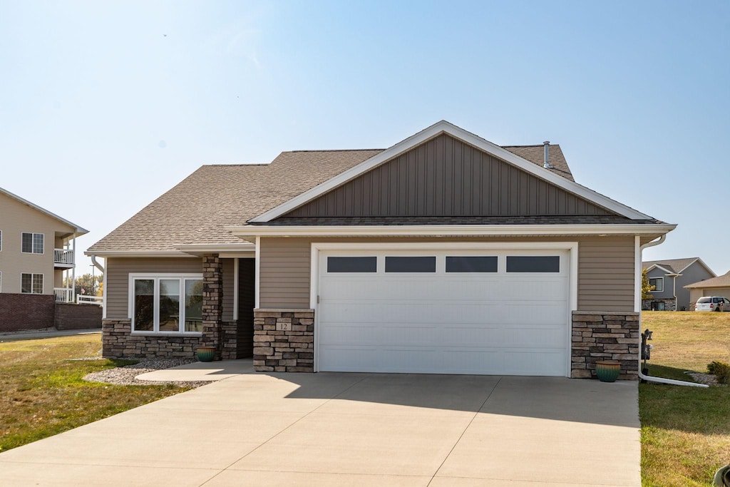 craftsman-style house featuring a front yard and a garage