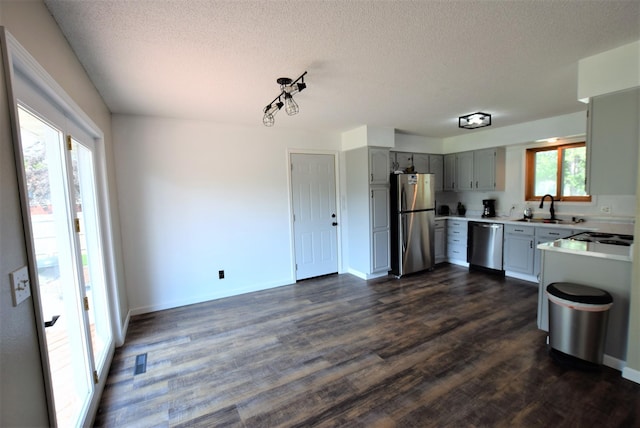 313 10th Ave NE, Roseau, MN 56751 - kitchen featuring a sink, stainless steel appliances, a textured ceiling, gray cabinets, and light countertops