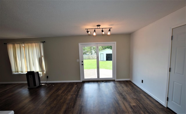 313 10th Ave NE, Roseau, MN 56751 - unfurnished living room featuring baseboards and dark wood-style floors