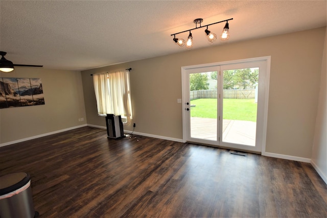 313 10th Ave NE, Roseau, MN 56751 - unfurnished living room featuring a ceiling fan, a textured ceiling, baseboards, visible vents, and dark wood-style floors