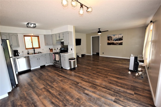 313 10th Ave NE, Roseau, MN 56751 - kitchen featuring a textured ceiling, under cabinet range hood, light countertops, appliances with stainless steel finishes, and dark wood-style floors