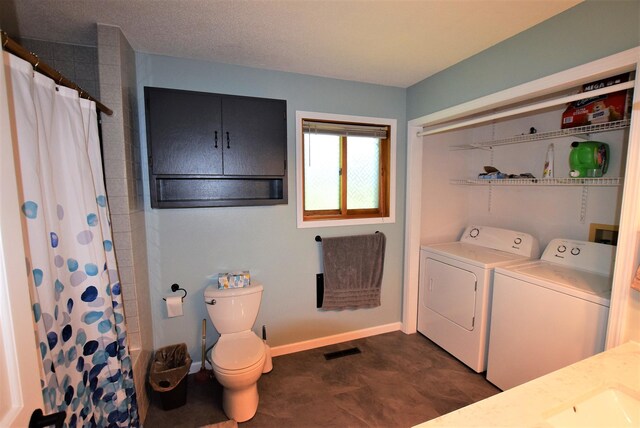 313 10th Ave NE, Roseau, MN 56751 - full bathroom with separate washer and dryer, toilet, a shower with curtain, and visible vents
