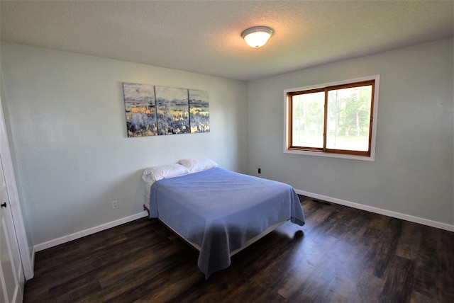 313 10th Ave NE, Roseau, MN 56751 - bedroom with baseboards and dark wood-style flooring