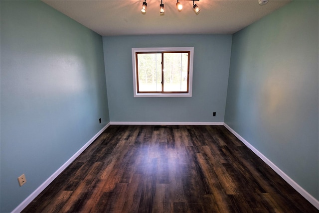 313 10th Ave NE, Roseau, MN 56751 - empty room featuring baseboards and dark wood-type flooring