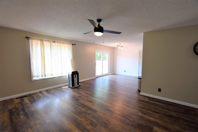 313 10th Ave NE, Roseau, MN 56751 - empty room with a textured ceiling, dark wood-style flooring, baseboards, and ceiling fan