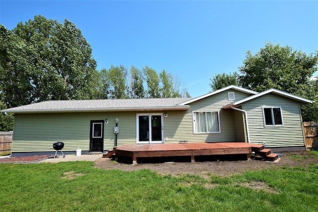 313 10th Ave NE, Roseau, MN 56751 - back of property featuring a yard, fence, and a deck