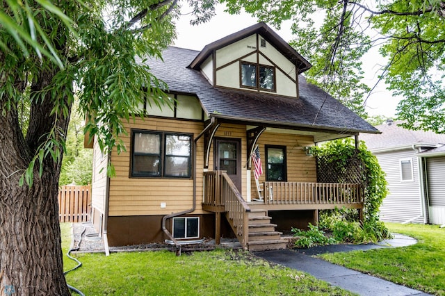 tudor-style house featuring a front lawn