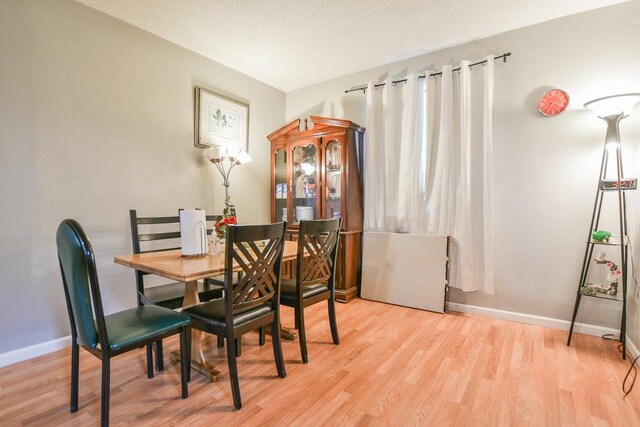 dining area with light hardwood / wood-style floors