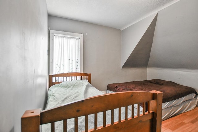 bedroom featuring hardwood / wood-style floors and a textured ceiling