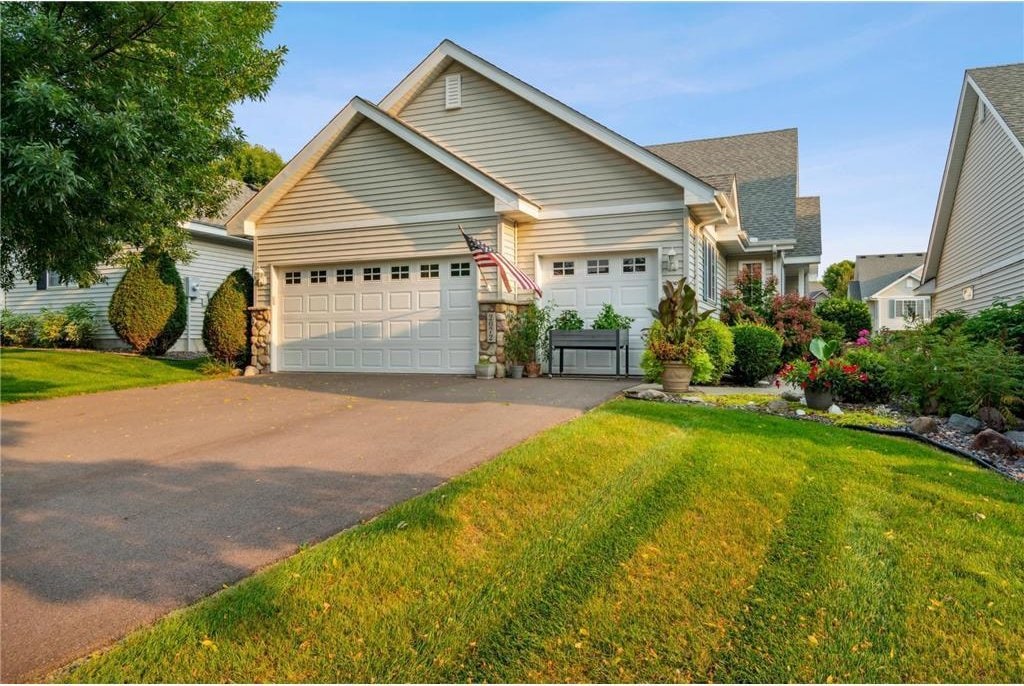 view of front of home featuring a garage and a front lawn