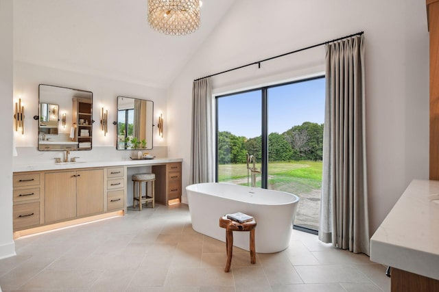 bathroom with vanity, a bathtub, high vaulted ceiling, and tile patterned floors