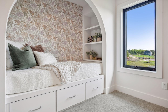 bedroom with multiple windows and light colored carpet