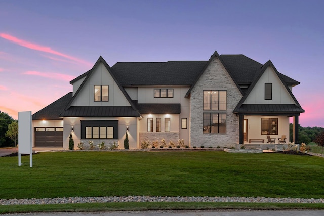 modern farmhouse style home with a lawn and a garage