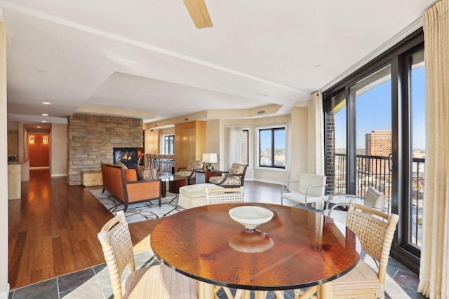 dining space with a fireplace and dark hardwood / wood-style floors