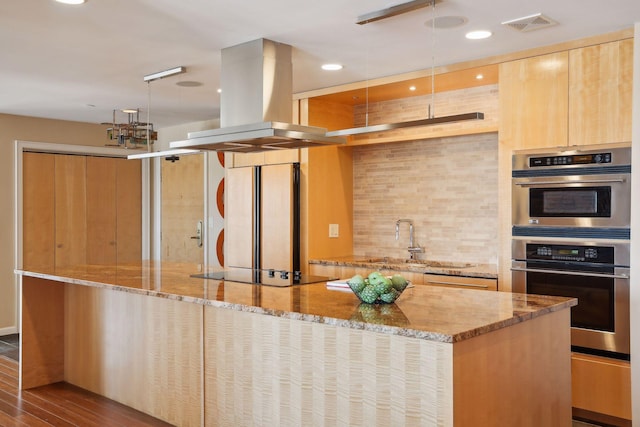 kitchen featuring island exhaust hood, light hardwood / wood-style flooring, sink, light stone countertops, and black electric stovetop