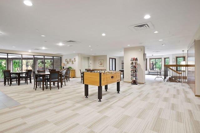 recreation room with plenty of natural light and light carpet