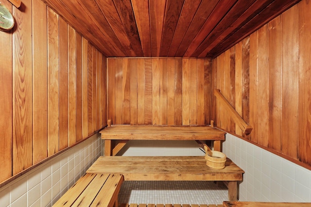 view of sauna featuring wood ceiling and wooden walls