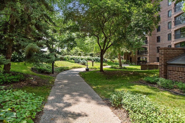 view of property's community with a lawn