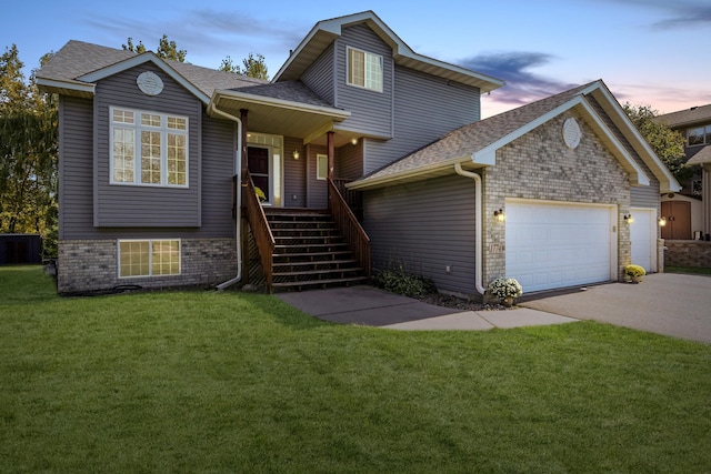 view of front of home with a lawn, a porch, and a garage