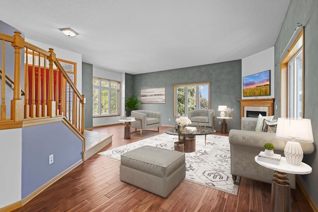 living room featuring plenty of natural light, dark wood-type flooring, and a textured ceiling