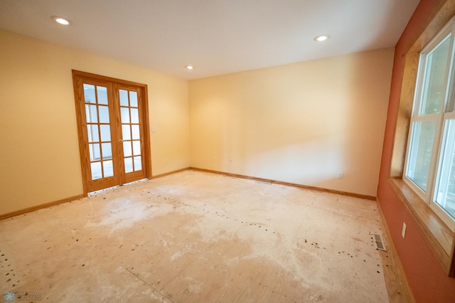 spare room featuring a wealth of natural light and french doors