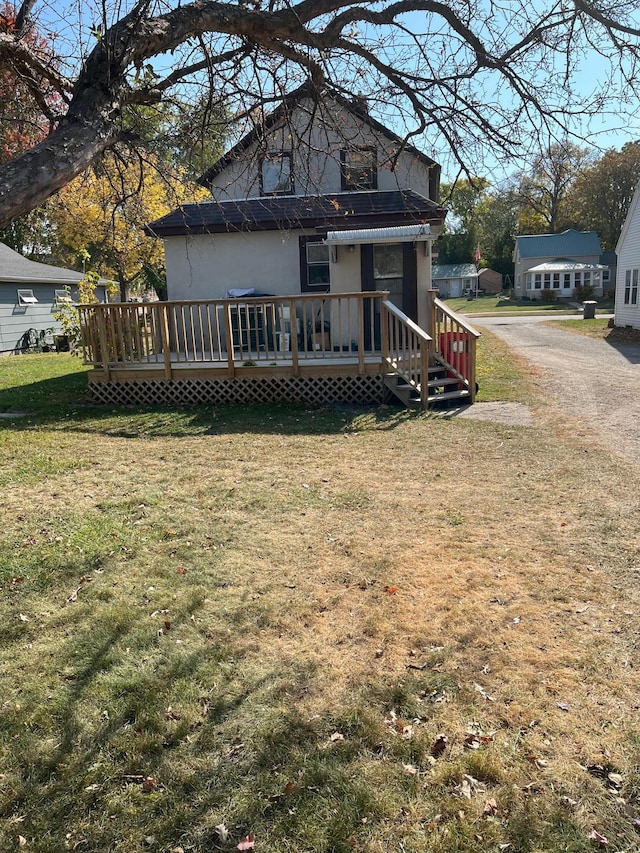 721 5th Ave E, Alexandria, MN 56308 - rear view of house featuring a wooden deck and a lawn