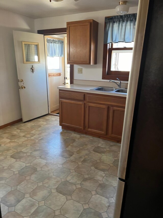 721 5th Ave E, Alexandria, MN 56308 - kitchen featuring plenty of natural light, light countertops, and brown cabinetry
