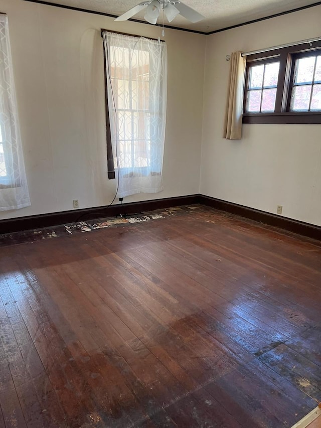 721 5th Ave E, Alexandria, MN 56308 - spare room with dark wood-type flooring, ceiling fan, and a textured ceiling