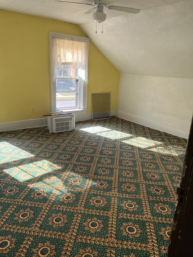 721 5th Ave E, Alexandria, MN 56308 - additional living space featuring a ceiling fan, vaulted ceiling, carpet floors, and a wall unit AC