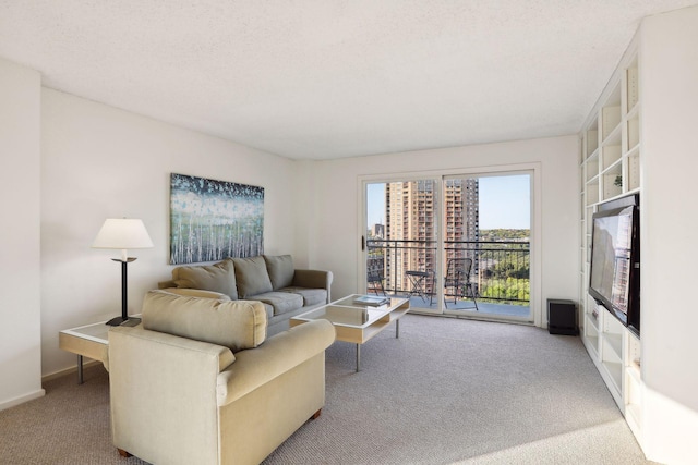 living room with a textured ceiling and carpet flooring