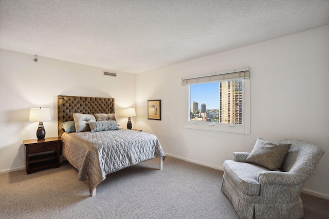 bedroom featuring carpet and a textured ceiling