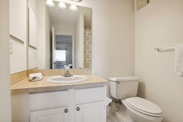 bathroom with vanity, tile patterned flooring, and toilet