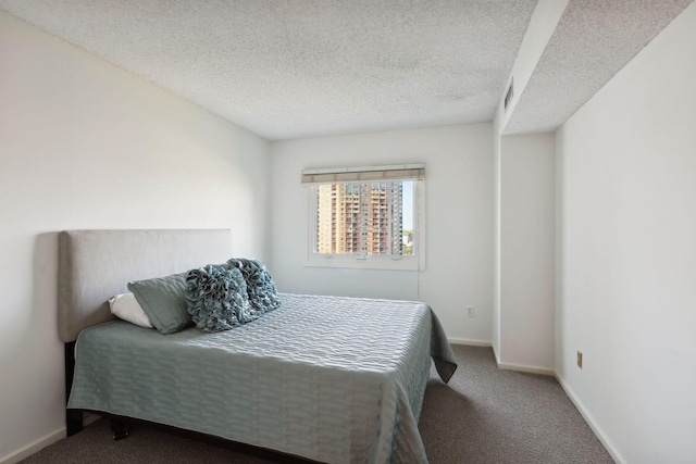 bedroom with carpet and a textured ceiling