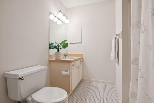 bathroom featuring vanity, tile patterned flooring, toilet, and a textured ceiling