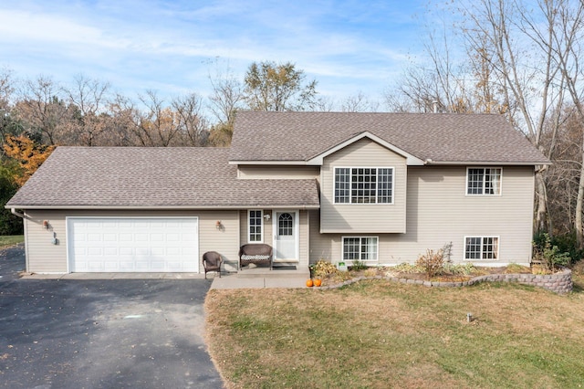 split level home with a front yard and a garage