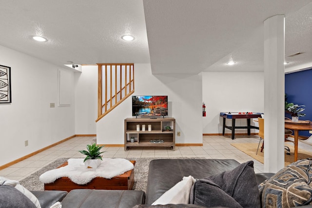 tiled living room featuring a textured ceiling